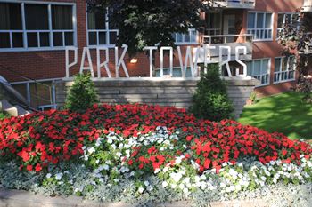 Park Towers Apartments in London, ON Beautifully manicured grounds with red and white flowers